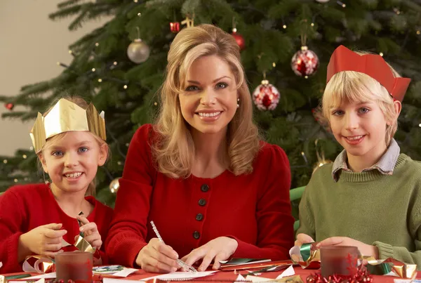 Mother And Children Making Christmas Cards Together