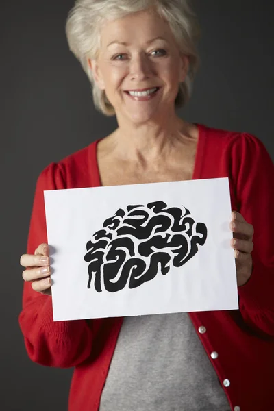Senior woman holding ink drawing of brain