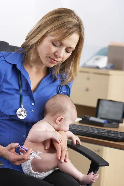 UK doctor vaccinating baby