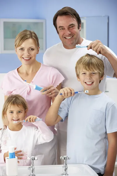Family cleaning teeth together in bathroom