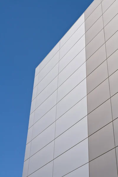 Steel facade on modern building over blue sky