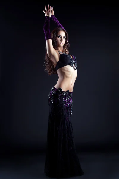 Sexy young woman dancing oriental dance