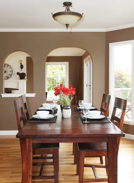 Dining room with brown walls and wood table.