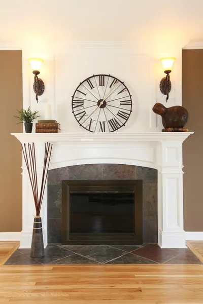 Luxury home white fireplace with stone and clock.