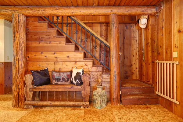 Rustic log cabin stairace and bench details.