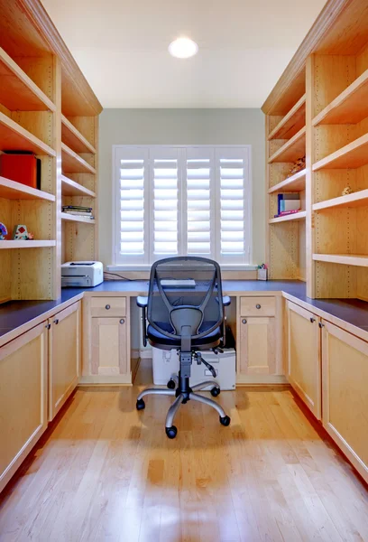 Small home office with shelves and desk.