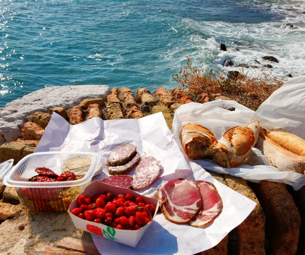 French food picnic outdoors near sea with market food.