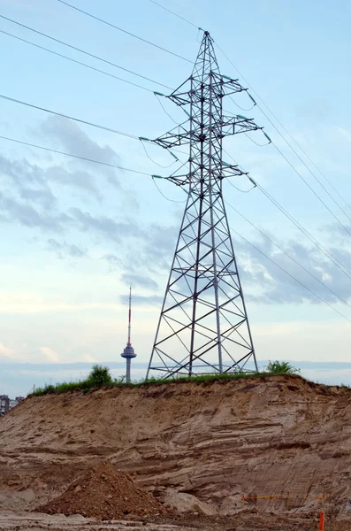 High-voltage power poles wires television tower