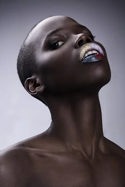 Black African American British fashion model with perfect skin long neck studio portrait