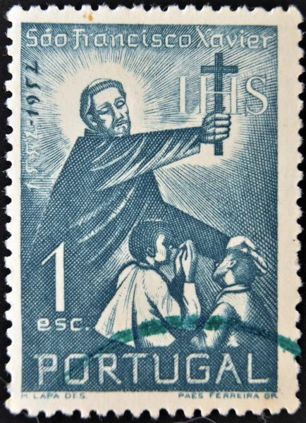 PORTUGAL - CIRCA 1952: stamp printed in Portugal shows Saint Francis Xavier holding a cross and blessing two children, circa 1952.