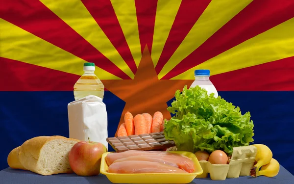 Basic food groceries in front of arizona us state flag
