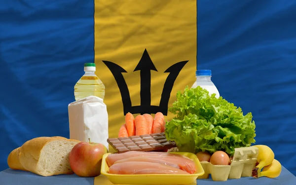 Basic food groceries in front of barbados national flag