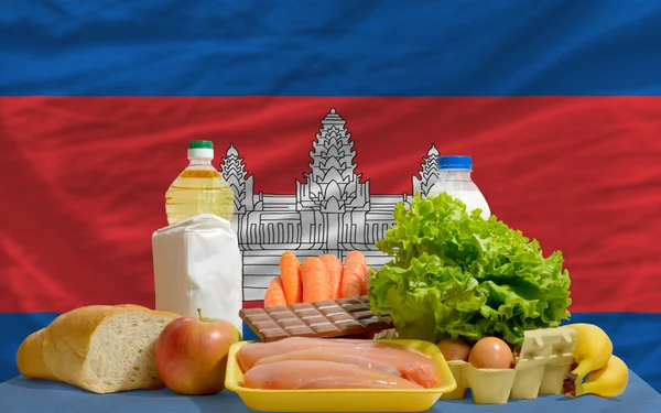 Basic food groceries in front of cambodia national flag