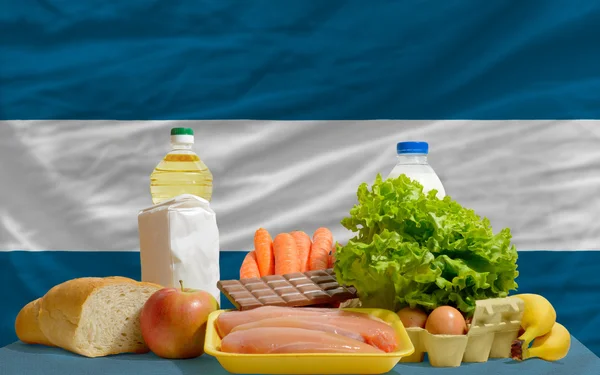 Basic food groceries in front of el salvador national flag