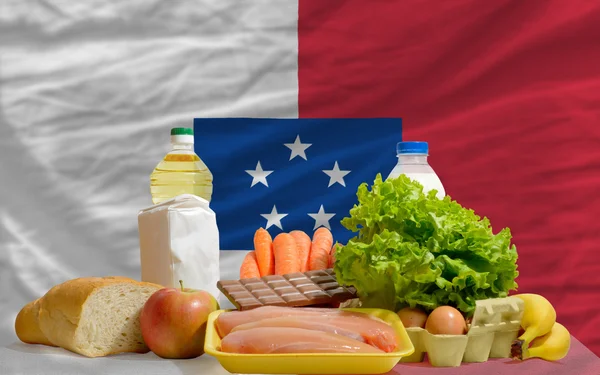 Basic food groceries in front of franceville national flag