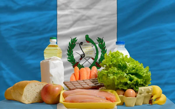 Basic food groceries in front of guatemala national flag