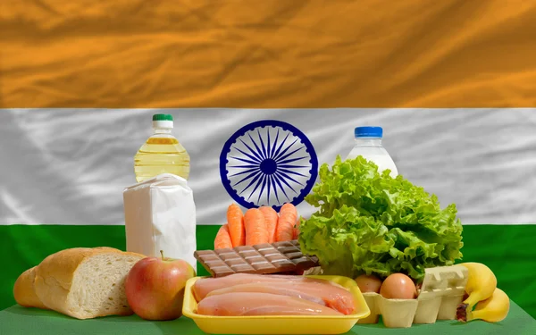Basic food groceries in front of india national flag