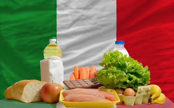 Basic food groceries in front of italy national flag