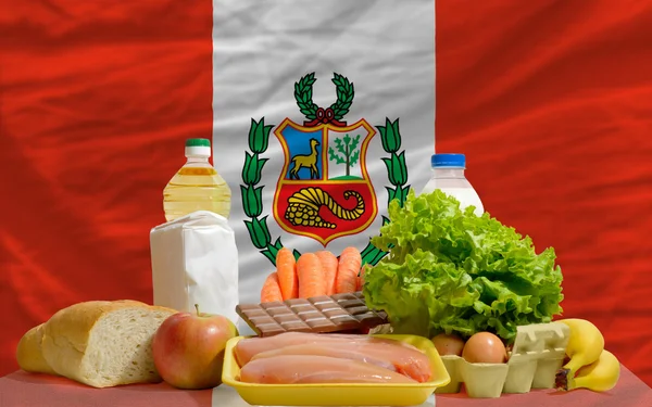 Basic food groceries in front of peru national flag