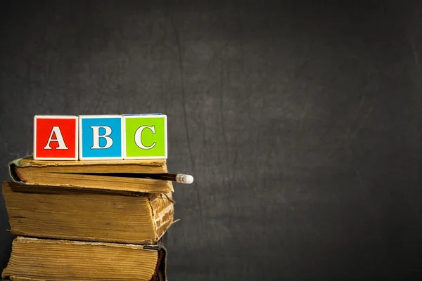 ABC on books against blackboard
