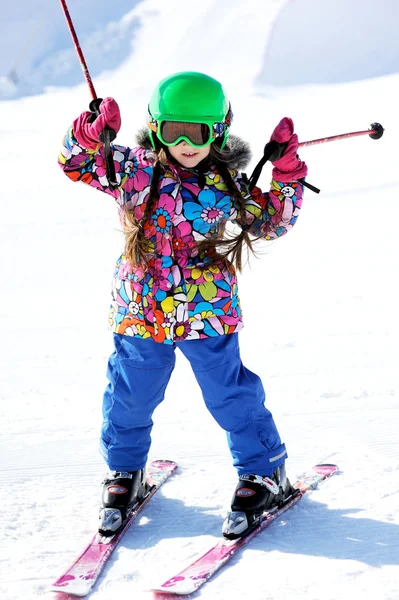 Portrait of little girl skier in sports suit