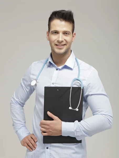 Handsome doctor holding a clipboard