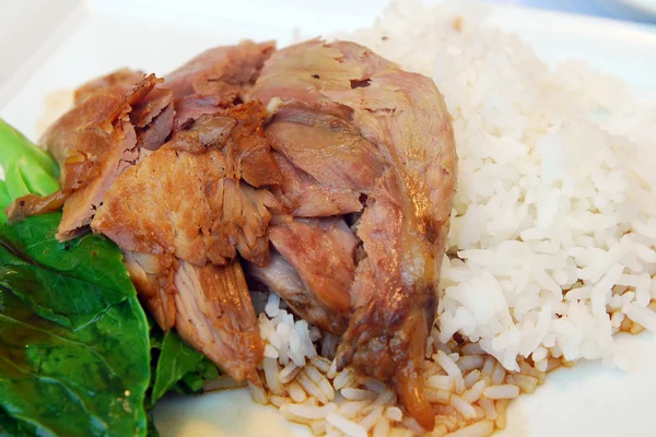 Stewed pork with cooked rice and egg on dish