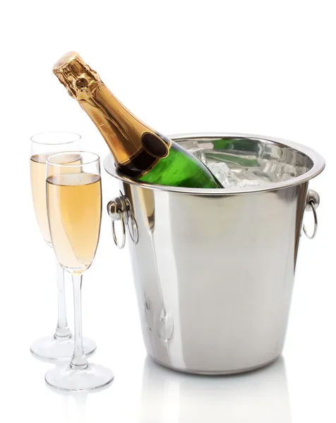 Champagne bottle in bucket with ice and glasses of champagne, isolated on white