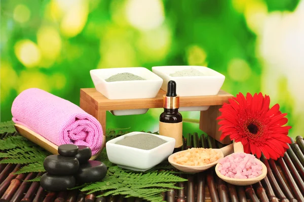 Cosmetic clay for spa treatments isolated on colorful green background