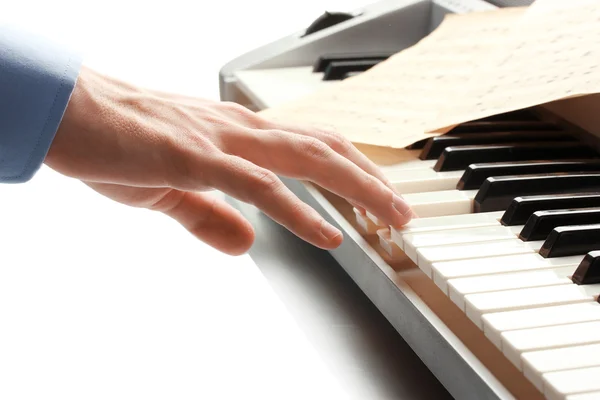 Hand of man playing piano