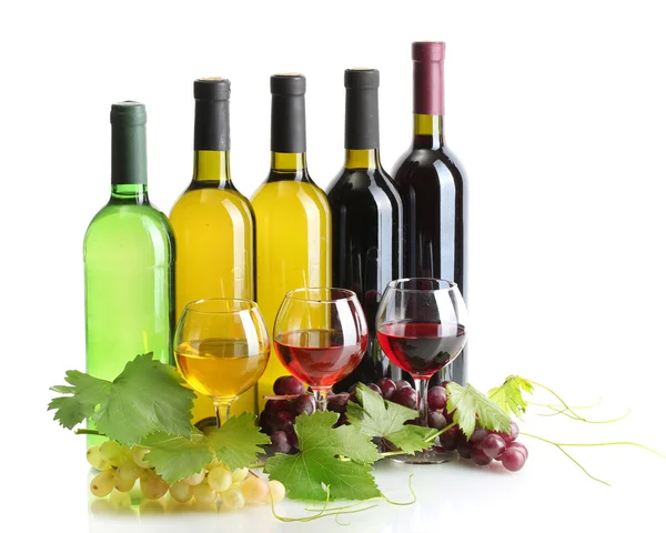 Bottles and glasses of wine and ripe grapes isolated on white