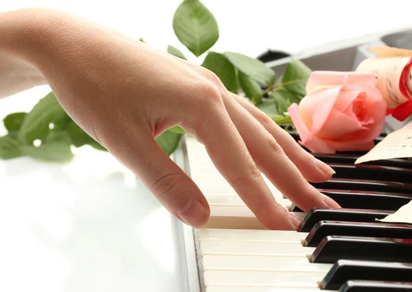 Hand of woman playing piano