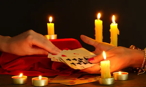 Fortune-telling and woman's hands on black backcground