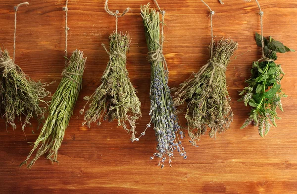 Dried herbs, on wooden background