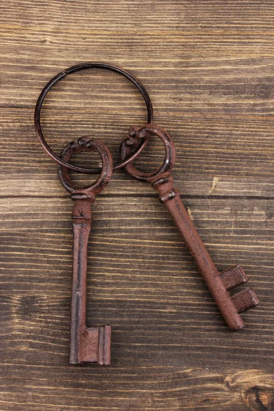A bunch of antique keys on wooden background