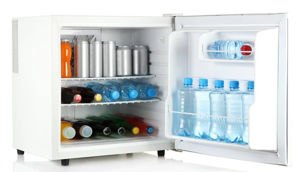 Mini fridge full of bottles and jars with various drinks isolated on white