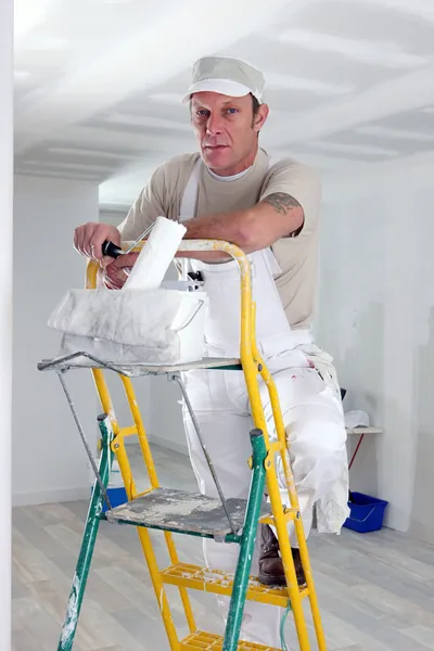 Painter climbing ladder