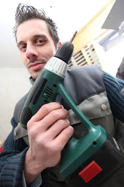 Man with a cordless drill