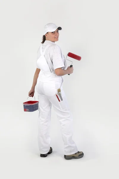 Woman painting wall red