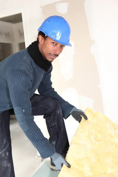 Construction worker insulating wall