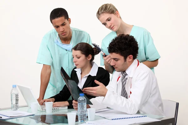 Medical staff gathered by desk