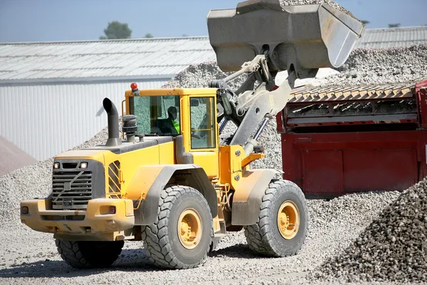 Construction vehicles transporting gravel