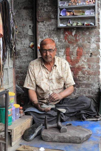 Tailoring and shoe repair shop on a street in North India