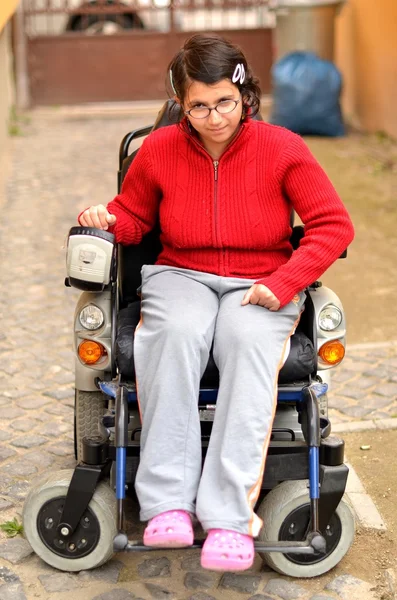 Young invalid woman on the wheelchair