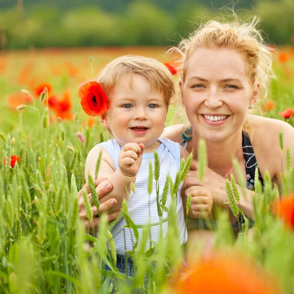 Mother and son in poppy field