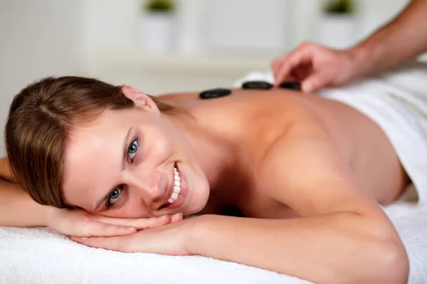 Relaxed woman receiving a massage at spa