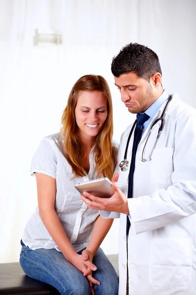 Latin doctor and a girl looking to tablet PC