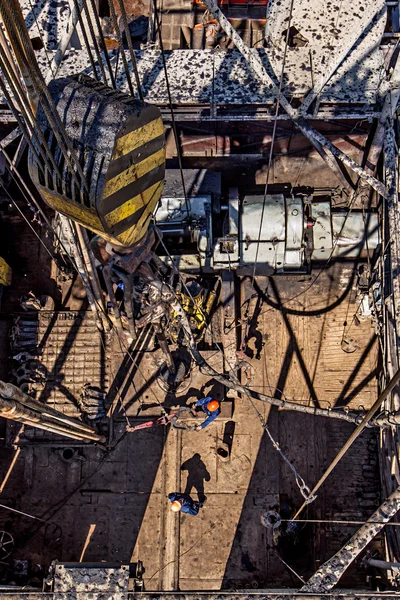 Workers on a gas well preparing the drill while mining the natural gas
