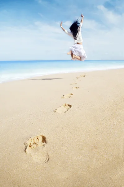 Woman with footprint enjoying freedom on beach