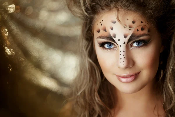 Girl with an unusual make-up as a leopard